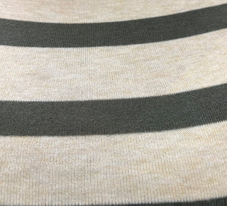 Close-up of a striped knit fabric with alternating wide cream-beige and dark olive horizontal bands.