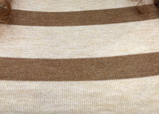 Close-up of a knit fabric with horizontal stripes in warm brown and cream.