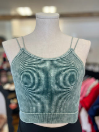 Green ribbed tank top on a mannequin with a blurred background