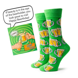 Green socks with beer mug pattern and birthday card on a white background