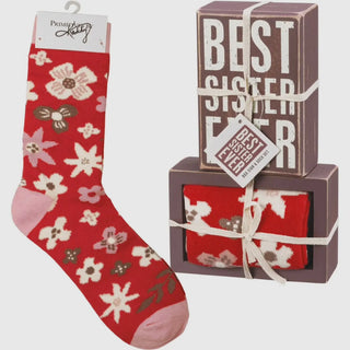 Red floral sock with packaging labeled 'Best Sister Ever' on a white background