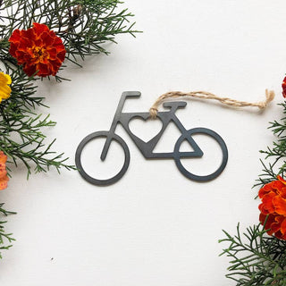 Bicycle-shaped ornament on a white background with floral decorations