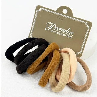 Eight fabric hair ties in black, brown, and light beige shades, displayed in front of a brown cardboard hanger tag printed with the brand name 'Paradise accessories'.