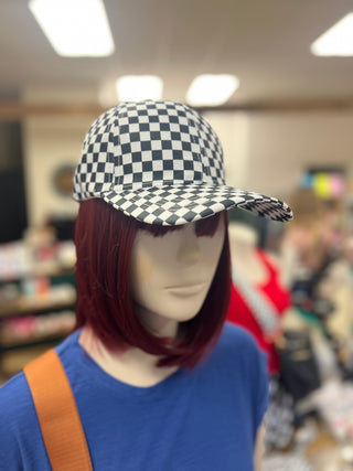 Mannequin head with a checkered cap in a store setting