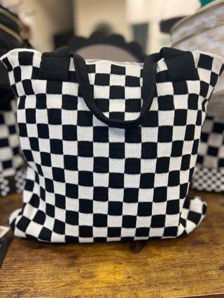 Black and white checkered bag on a wooden surface
