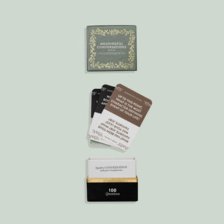 Card game packaging with question cards on a light gray background