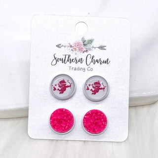 Pair of earrings with pink and silver design on a 'Southern Charm Trading Co' card.