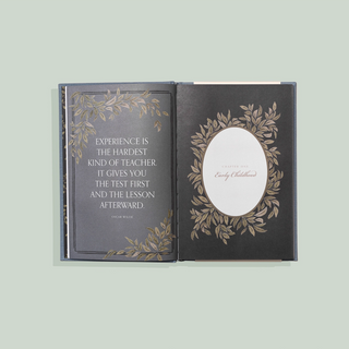 Decorative book with a quote and floral design on a light green background