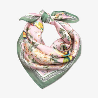 Floral and bird patterned scarf with green border on a white background