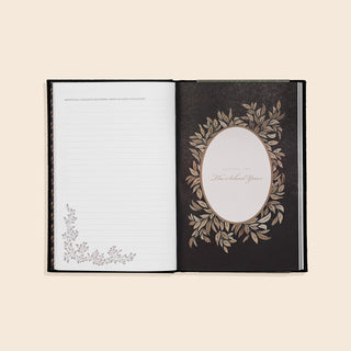 Open book with decorative cover and page on a beige background