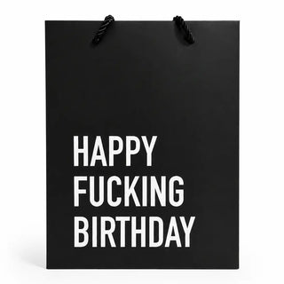 A black paper gift bag with black rope handles, featuring the text 'HAPPY FUCKING BIRTHDAY' in bold white capital letters, shown against a plain white background.