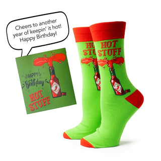 Green socks with red accents and a matching birthday card on a white background