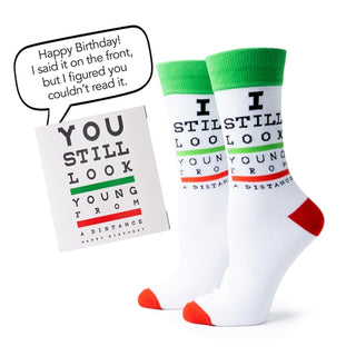Two pairs of socks with humorous text and a card on a white background