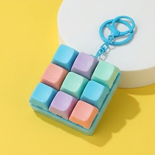 Colorful keychain shaped like a square with pastel-colored keys on a yellow background