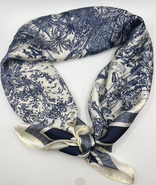Navy and white floral patterned scarf tied on a white background