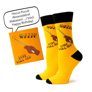 Yellow socks with black accents and a 'Shazam!' card on a white background