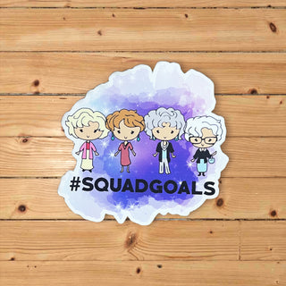 Sticker with cartoon characters and '#SQUADGOALS' text on a wooden background