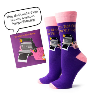 Purple socks with pink accents and a matching card on a white background