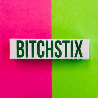 Rectangular product with 'BITCHSTIX' text on a pink and green background